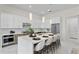 Modern kitchen with white cabinetry, stainless steel appliances, and a center island with seating at 3411 W El Prado Blvd, Tampa, FL 33629