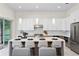 Modern kitchen with white cabinetry, a large center island, and stainless steel appliances at 3411 W El Prado Blvd, Tampa, FL 33629