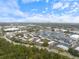 High angle view features community, apartment homes, clubhouse, nearby roads, and verdant tree line, with a distant cityscape at 3585 41St S Ter # 227, St Petersburg, FL 33711