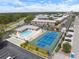 A high angle aerial shot of the community tennis court, pool, shuffleboard, parking and apartment buildings at 3585 41St S Ter # 227, St Petersburg, FL 33711