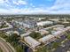Expansive aerial view of a community with modern apartments, a tennis court, and a swimming pool; downtown skyline visible at 3585 41St S Ter # 227, St Petersburg, FL 33711