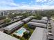 Aerial view of multiple unit buildings, community pool, and lush landscaping at 3585 41St S Ter # 227, St Petersburg, FL 33711
