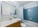 Bathroom showcasing a tub and shower combination with blue tiled walls and a white vanity at 3585 41St S Ter # 227, St Petersburg, FL 33711