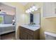 Bright bathroom featuring a marble countertop, decorative vanity, and modern lighting fixtures at 3585 41St S Ter # 227, St Petersburg, FL 33711