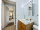 An open bathroom with a wood vanity, view of the bedroom, and medicine cabinet at 3585 41St S Ter # 227, St Petersburg, FL 33711