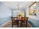 Inviting dining room featuring a wood table and chairs under an elegant light fixture at 3585 41St S Ter # 227, St Petersburg, FL 33711