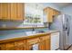 The kitchen has light wood cabinets, and stainless steel appliances at 3585 41St S Ter # 227, St Petersburg, FL 33711