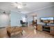 Comfortable living room with ceiling fan, wood floors, and access to the dining room create a cozy atmosphere at 3585 41St S Ter # 227, St Petersburg, FL 33711