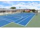 Enjoy a game on the blue and green tennis court with the apartment buildings in the background at 3585 41St S Ter # 227, St Petersburg, FL 33711