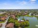 Aerial view overlooking residential community with lake, pool, and beautiful green landscaping at 4022 Lighthouse Way, New Port Richey, FL 34652