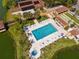 Bird's eye view of a bright, blue community pool and spa with lounge chairs at 4022 Lighthouse Way, New Port Richey, FL 34652