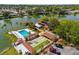 Community amenities featuring a pool, shuffleboard, and picturesque lake views at 4022 Lighthouse Way, New Port Richey, FL 34652