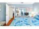 Bedroom with blue patterned bedding, dresser with mirror, and doorway leading to other rooms at 4022 Lighthouse Way, New Port Richey, FL 34652
