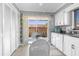 Cozy kitchen features white cabinets, stainless steel sink, and a sliding glass door with a patio view at 4022 Lighthouse Way, New Port Richey, FL 34652