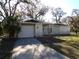 Ranch style home with a one car garage and mature landscaping at 4405 Coconut Cove Pl, Valrico, FL 33596