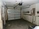 Unfinished garage with a door, electrical panel and visible mold at 4405 Coconut Cove Pl, Valrico, FL 33596