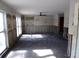 Unfinished living room featuring two windows, ceiling fan and access to other rooms at 4405 Coconut Cove Pl, Valrico, FL 33596