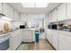 Well-equipped kitchen with modern appliances, including a dishwasher, and a view into the dining area at 4424 Pelorus Dr, New Port Richey, FL 34652
