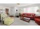 Bright and inviting living room with neutral carpeting, white walls, and comfortable seating arrangements at 4424 Pelorus Dr, New Port Richey, FL 34652