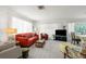 Comfortable living room featuring neutral carpeting, bright white walls, and cozy seating area at 4424 Pelorus Dr, New Port Richey, FL 34652
