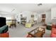 Open concept living room with neutral carpeting, white walls, and comfortable seating and dining areas at 4424 Pelorus Dr, New Port Richey, FL 34652