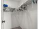 Functional walk-in closet with ample storage space, organized with shelves and hanging rods for clothes and accessories at 4424 Pelorus Dr, New Port Richey, FL 34652