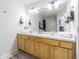 Well-lit bathroom with double sinks, vanity, and large mirror at 4603 Barnstead Dr, Riverview, FL 33578