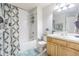 Well-lit bathroom featuring a shower-tub combo and wooden vanity at 4603 Barnstead Dr, Riverview, FL 33578