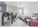 Neutral-toned bedroom with a bed, a desk with computer, and a leather recliner at 4603 Barnstead Dr, Riverview, FL 33578
