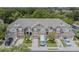A row of townhomes, each with a garage, complemented by green trees and a paved parking area at 4603 Barnstead Dr, Riverview, FL 33578