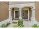 Close-up view of the front doors of a townhome with a covered entryway and manicured landscaping at 4603 Barnstead Dr, Riverview, FL 33578