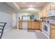 Well-lit kitchen featuring light wood cabinets and an open layout with a view into the living room at 4603 Barnstead Dr, Riverview, FL 33578