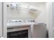 Practical laundry room features a washer, dryer, and storage shelf at 4603 Barnstead Dr, Riverview, FL 33578