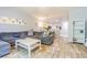 Comfortable living room with a large gray sofa, white coffee table, and a view into the kitchen and dining area at 4603 Barnstead Dr, Riverview, FL 33578