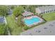 Aerial view of a community pool, featuring a lounge area and lush green landscaping at 4603 Barnstead Dr, Riverview, FL 33578