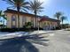 Community clubhouse with white stone landscaping, pillars, and palm tree landscaping at 5020 Brittany S Dr # 212, St Petersburg, FL 33715