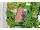 Overhead view of a home featuring fenced yard, a patio area with seating, and mature tree coverage at 533 Keene Rd, Largo, FL 33771
