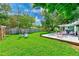 Lush backyard with a deck and seating areas and a manicured lawn at 533 Keene Rd, Largo, FL 33771