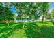 Expansive backyard with lush greenery, mature trees, and ample space for outdoor activities and entertaining at 533 Keene Rd, Largo, FL 33771