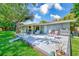 Spacious backyard with deck, patio furniture, and lush green lawn at 533 Keene Rd, Largo, FL 33771