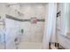 Modern bathroom shower featuring tiled walls, recessed shelving, and chrome fixtures at 533 Keene Rd, Largo, FL 33771