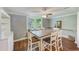Cozy dining room featuring a rustic wood table, hardwood floors, and ample natural light at 533 Keene Rd, Largo, FL 33771