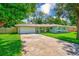 Attractive single-story home with well-manicured lawn, mature trees, and a convenient two-car garage at 533 Keene Rd, Largo, FL 33771