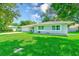 Well-maintained home featuring a spacious front yard, lush lawn, and a charming, inviting facade at 533 Keene Rd, Largo, FL 33771