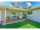 Charming front porch with brick accents, complemented by lush landscaping and welcoming decor at 533 Keene Rd, Largo, FL 33771