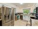Well-lit kitchen with stainless steel appliances, granite counters, and tiled backsplash at 533 Keene Rd, Largo, FL 33771