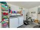 Laundry room with washer, dryer, storage racks and utility sink at 533 Keene Rd, Largo, FL 33771