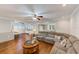 Bright living room with a breakfast bar that leads to the kitchen with white cabinets at 533 Keene Rd, Largo, FL 33771