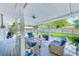 Covered patio with comfortable wicker seating, outdoor grill and fenced yard at 533 Keene Rd, Largo, FL 33771