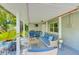 Covered patio with wicker seating, ceiling fan and mini fridge at 533 Keene Rd, Largo, FL 33771